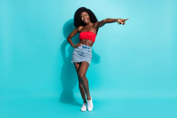 Full length photo of confident sweet dark skin lady pointing finger empty space smiling empty space isolated blue color background — Stock Photo, Image