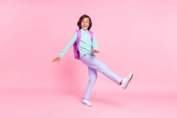 Photo of glad nice carefree schoolboy party dance wear bag specs teal shirt isolated pink color background — Stock Photo, Image