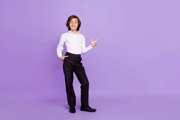 Full length photo of funky little brunet boy point wear formalwear trousers sneakers isolated on purple color background — Stock Photo, Image