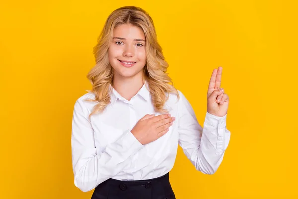 Zdjęcie pozytywnej lojalnej uczennicy zrobić gest nowicjusza nosić białą koszulę odizolowany żółty kolor tła — Zdjęcie stockowe