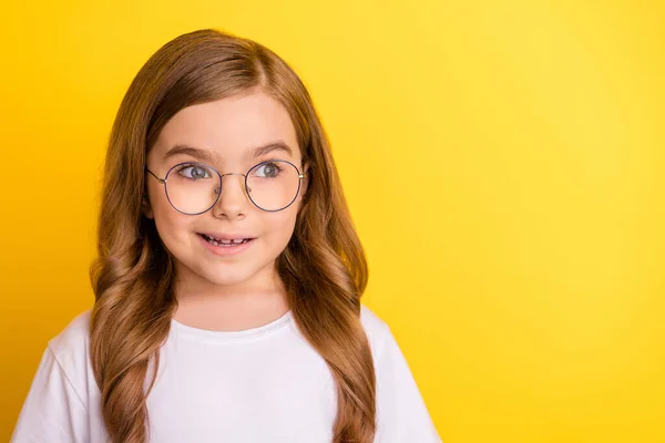 Photo of young school girl happy positive smile amazed surprised look empty space isolated over yellow color background — Stock Photo, Image