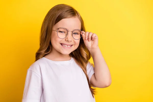 Photo of young excited small girl happy positive smile cheerful wear glasses isolated over yellow color background — Stock Photo, Image