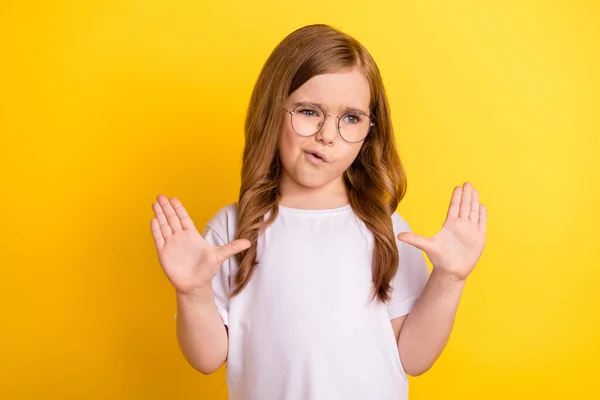 Photo of young little girl unhappy negative gesture hands no stop refuse reject sign isolated over yellow color background — Stock Photo, Image