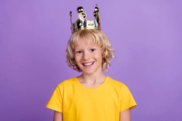 Zdjęcie pozytywnego księcia królewskiego dziecko błyszczący biały uśmiech nosić złoty korona żółty t-shirt odizolowany fioletowy kolor tło — Zdjęcie stockowe