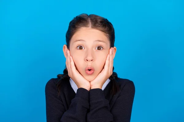 Photo of shocked amazed crazy schoolgirl touch cheekbones big sale discount black friday isolated on blue color background