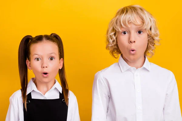 Photo de deux écoliers choqués excités omg réaction usure uniforme scolaire isolé couleur jaune fond — Photo