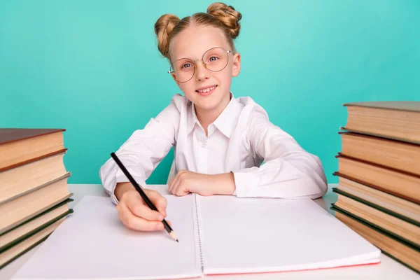 Photo of optimistic little girl write wear white shirt spectacles isolated on teal background — Stock Photo, Image