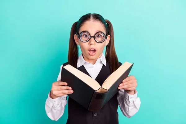 Foto retrato menina em óculos livro de leitura animado espantado abriu boca isolado pastel turquesa cor fundo — Fotografia de Stock