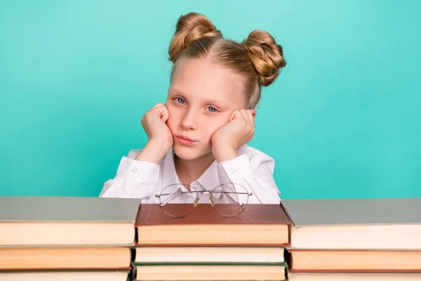 Photo of tired small girl with books wear white shirt spectacles isolated on teal background — Stock Photo, Image