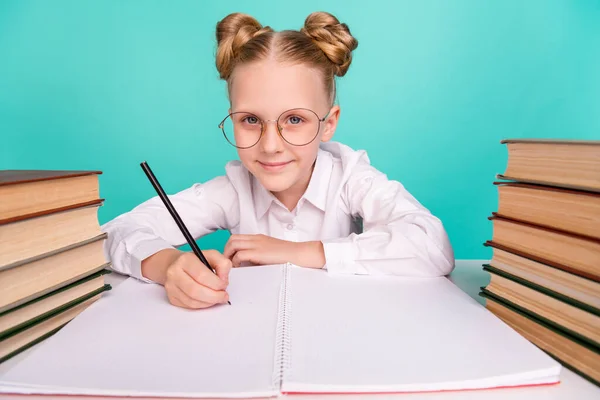 Photo of sweet small girl write wear white shirt spectacles isolated on teal background — Stock Photo, Image