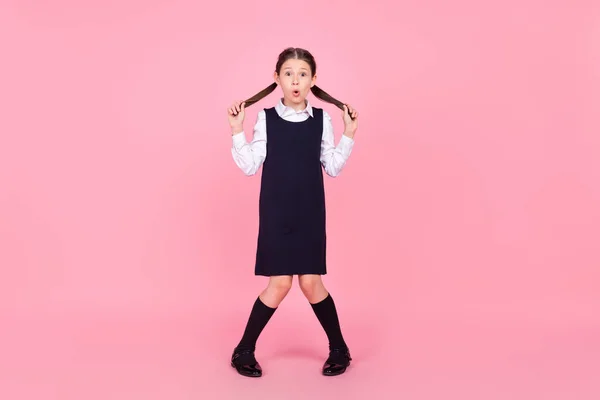 Full size photo of young school girl amazed shocked surprised shy isolated over pink color background — Stock Photo, Image