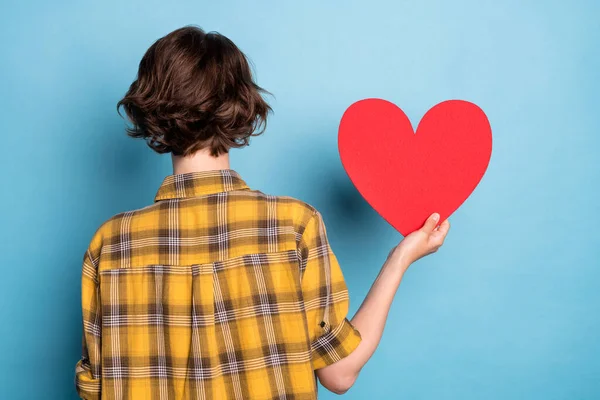 Rear back view photo of lady demonstrate red paper heart card wear checkered shirt isolated blue color background — Stock Photo, Image