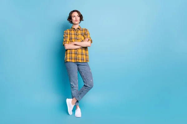 Photo of pensive lady crossed arms look empty space wear plaid shirt jeans shoes isolated blue color background — Stock Photo, Image