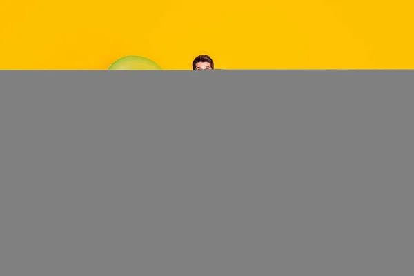 Photo of impressed sweet young guy shirtless dressed dark glasses hands arms sides isolated yellow color background — Stock Photo, Image