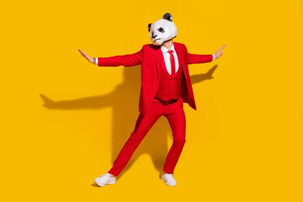 Foto de chico panda novio coqueta disfrutar de baile retro desgaste máscara esmoquin rojo corbata zapatos aislados sobre fondo de color amarillo —  Fotos de Stock