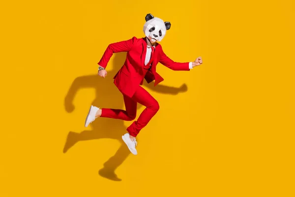 Foto de funky pressa panda cara salto pressa tarde desgaste máscara vermelho smoking tênis isolado no fundo de cor amarela — Fotografia de Stock