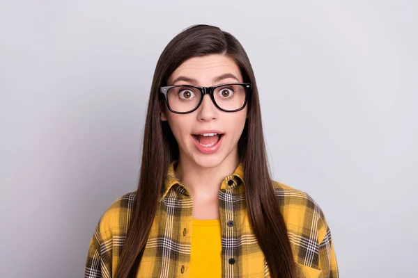 Foto di cute impressionato giovane donna vestita a scacchi occhiali camicia sorridente bocca aperta isolato colore grigio sfondo — Foto Stock