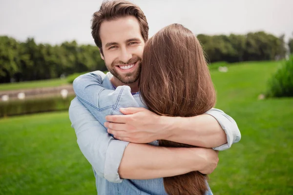 Photo of positive lovely cute beautiful couple hug embrace relaxing outdoors husband cuddle wife romantic date — Stock Photo, Image