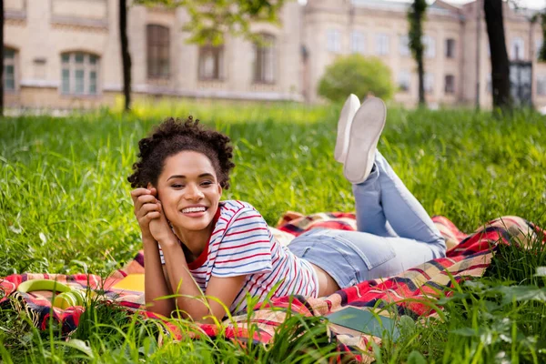도시 공원에서 대학 시험 준비를 하는 담요 위에 누워 있는 행복 한 소녀의 전체 몸길이 — 스톡 사진