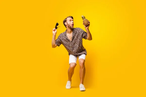Full length photo of charming cute young guy wear leopard outfit arm dark eyewear pineapple dancing isolated yellow color background — Stock Photo, Image