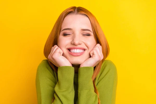 Photo of cute orange hair millennial lady hands chin wear green sweater isolated on yellow color background — Stock Photo, Image