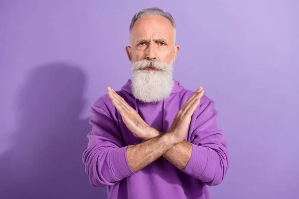 Portrait of elderly retired pensioner grey-haired manwear hoodie showing crossed hands isolated over purple violet color background — Stock Photo, Image