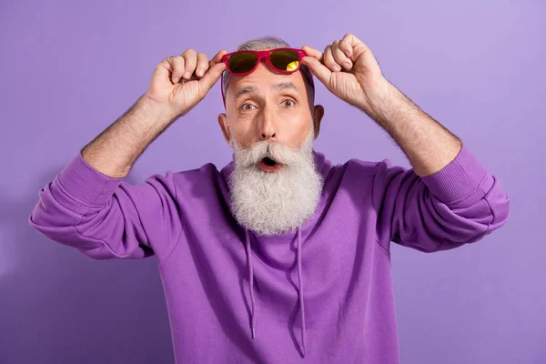 Retrato de idosos funky surpreendido hipster homem de cabelos grisalhos tocando especificações notícias reação isolada sobre fundo cor violeta roxo — Fotografia de Stock