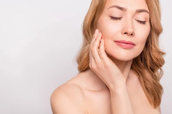 Cropped photo portrait woman naked shoulders applying anti age nourishing cream on face isolated white color background — Stock Photo, Image