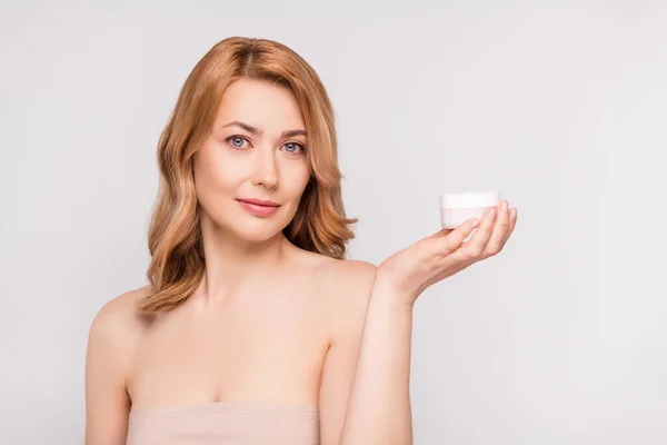 Retrato de atractiva mujer sana sosteniendo en la palma crema hidratante anuncio aislado sobre fondo de color pastel gris — Foto de Stock
