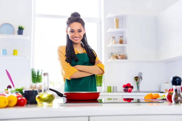 Photo of cute sweet dark skin woman dressed yellow shirt cooking arms crossed smiling indoors house home room — Stock Photo, Image