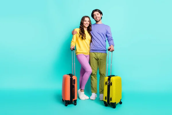 Foto de larga duración de la joven pareja feliz sonrisa positiva viaje turístico maleta vuelo aislado sobre fondo de color verde azulado — Foto de Stock