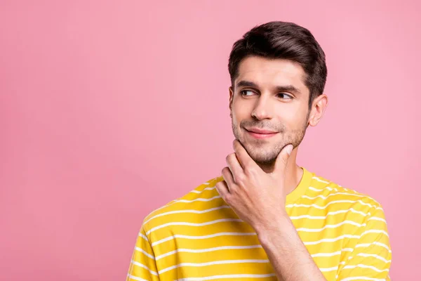 Foto van nieuwsgierige brunet jongeman kijken lege ruimte dragen gele t-shirt geïsoleerd op roze kleur achtergrond — Stockfoto