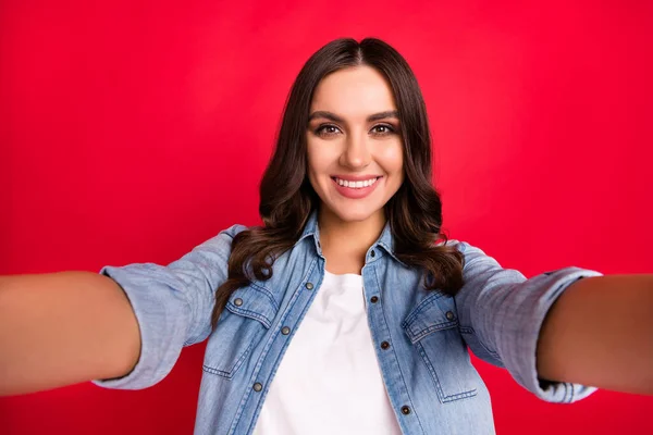 Photo of young attractive girl happy positive smile make selfie blogger isolated over red color background — Stock Photo, Image