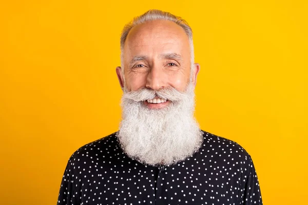 Фотопортрет бородатый мужчина в черной рубашке улыбается счастливый изолированный ярко-желтый цвет фона — стоковое фото