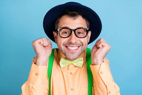 Фото смішного брюнетки чоловік руки кулаки носять головний убір окуляри персикові сорочки окуляри окуляри окуляри окуляри вистави ізольовані на синьому кольоровому фоні — стокове фото