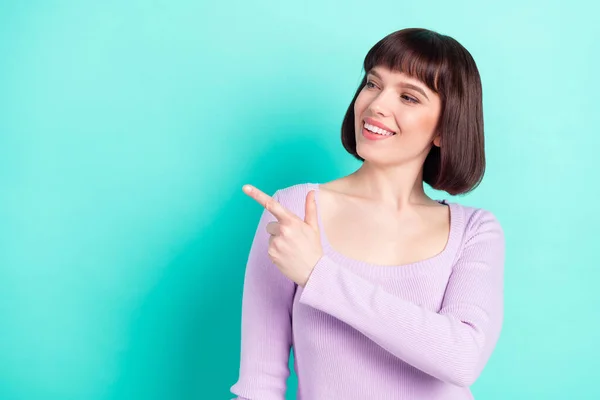 Foto retrato mulher com bob cabelo sorridente apontando dedo copyspace isolado vivo teal cor fundo — Fotografia de Stock