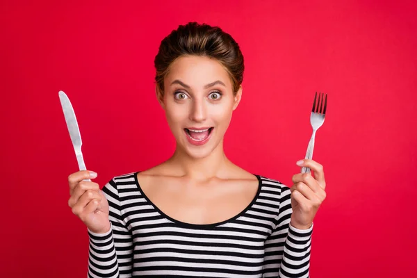 Photo of shiny impressed young woman dressed striped outfit arm smiling ready for dinner isolated red color background — Stock Photo, Image