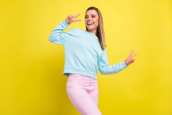 Portrait of attractive nice cheerful girl dancing showing v-sign having fun isolated over bright yellow color background — Stock Photo, Image