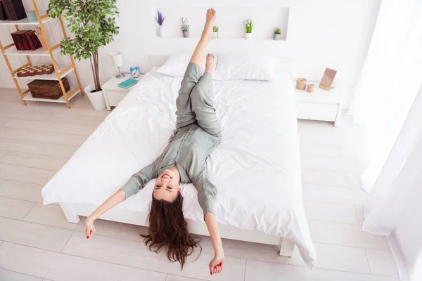 Top above high angle view portrait of attractive cheerful girl lying on bed stretching good mood at home house light white interior — Stock Photo, Image