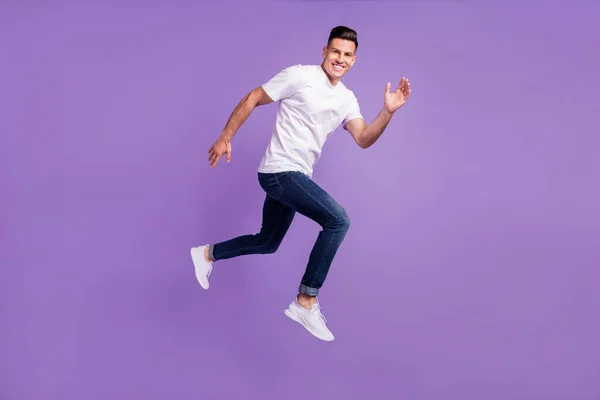 Profil complet du corps photo latérale du jeune homme heureux sourire positif aller marcher courir sauter dépêcher isolé sur fond de couleur violette — Photo