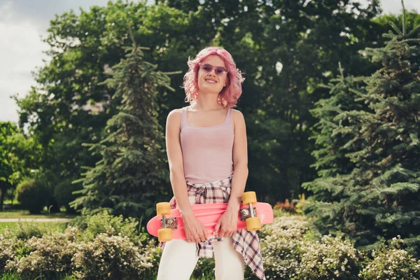 Porträt eines attraktiven fröhlichen, unbeschwerten, sportlichen Mädchens, das seine Freizeit am Wochenende mit Skateboarden an der frischen Luft verbringt — Stockfoto