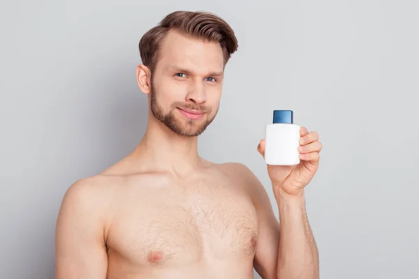 Photo of nice young blond man hold bottle without clothes isolated on grey color background — Stock Photo, Image