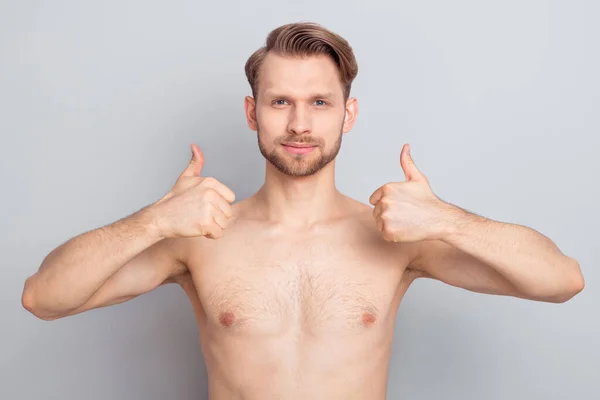 Photo of adorable sweet blond hair young guy no clothes smiling showing two thumbs up isolated grey color background — ストック写真