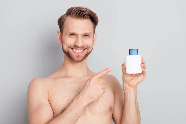 Portrait of attractive cheerful nude man demonstrating new perfume smell aroma isolated over grey pastel color background — Stock Photo, Image