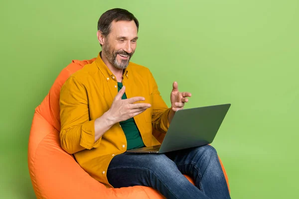 Profile side photo of mature man happy positive smile meeting video conference laptop isolated over green color background — Stock Photo, Image