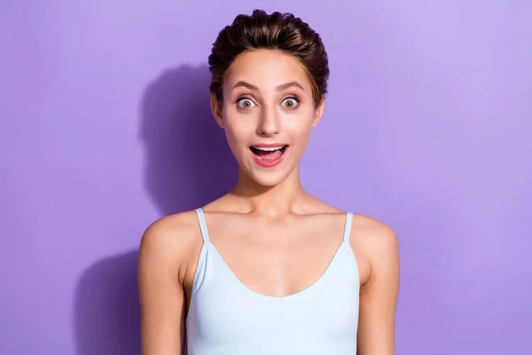 Foto ritratto ragazza in blu top sorridente guardando stupito isolato colore viola pastello sfondo — Foto Stock
