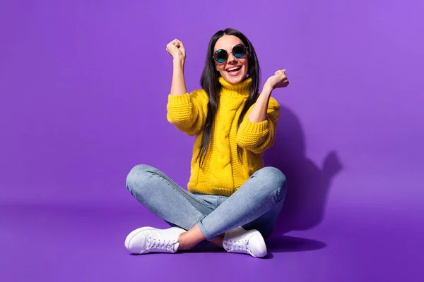 Full size portrait of astonished lady sit fists up open mouth smile yeah isolated on purple color background — Stock Photo, Image