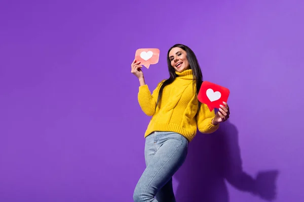 Full length photo of charming positive girl hands hold like paper cards beaming smile isolated on violet color background — Stok Foto