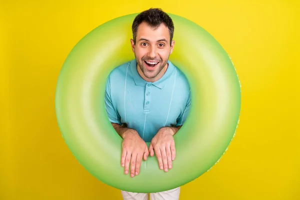 Foto van vrolijke brunet man in cirkel dragen blauwe t-shirt geïsoleerd op gele kleur achtergrond — Stockfoto