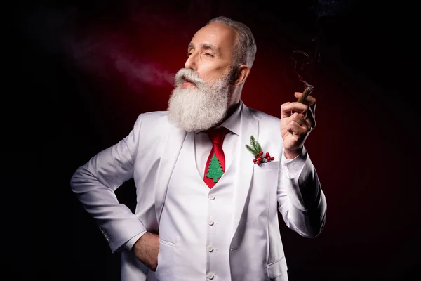 Profile side photo of mature handsome man enjoy smoke cigarette elegant suit isolated over dark color background — Stock Photo, Image